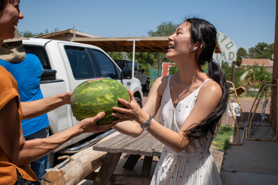 Students help unload watermelons from back of truck