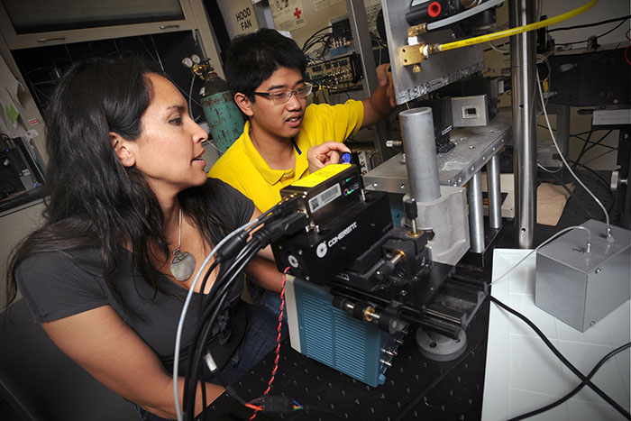 Professor and student work with flow cytometry equipment