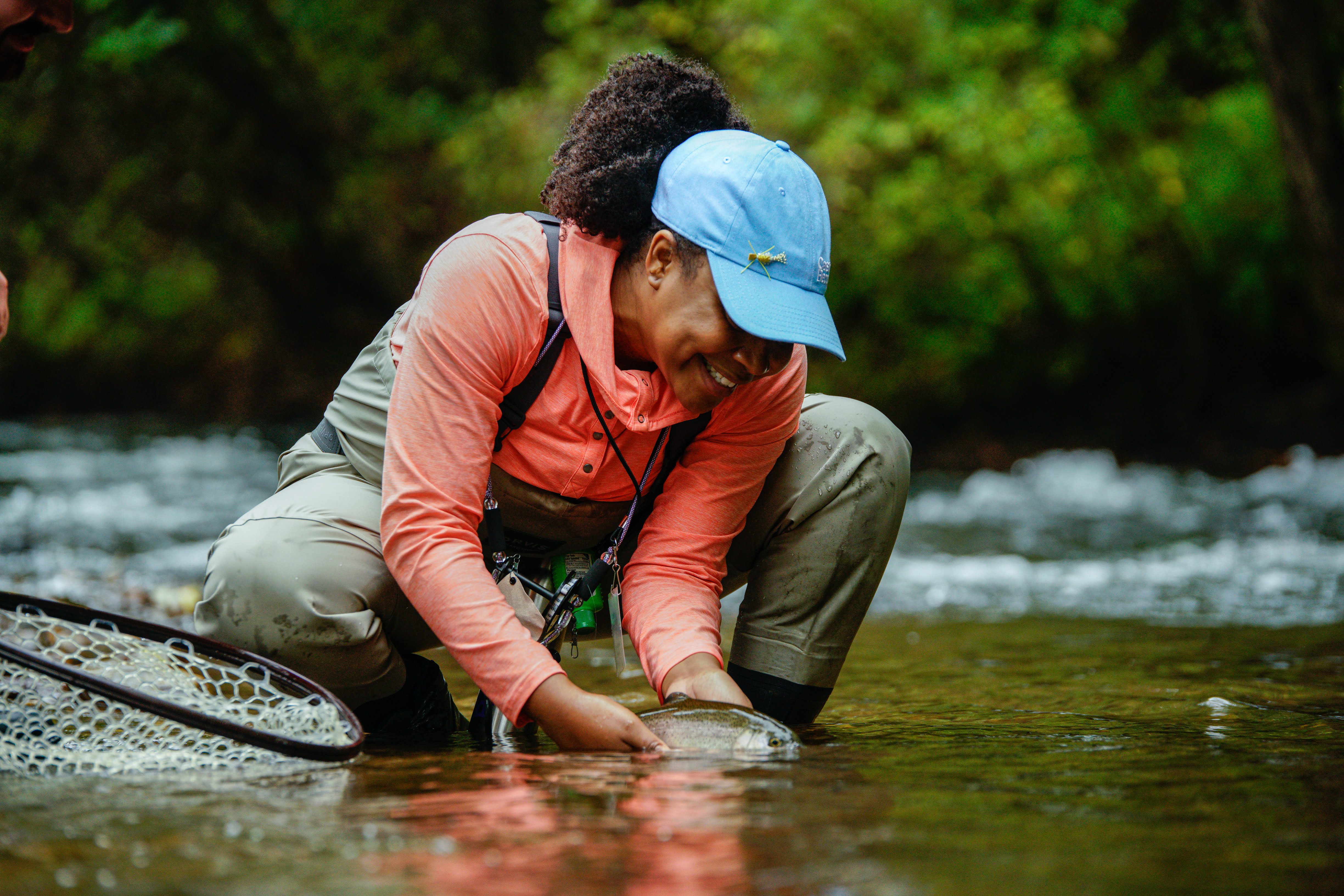 Female bending down in the river 